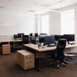 IT open space office. Computer Work Stations. Office Workplace with windows.